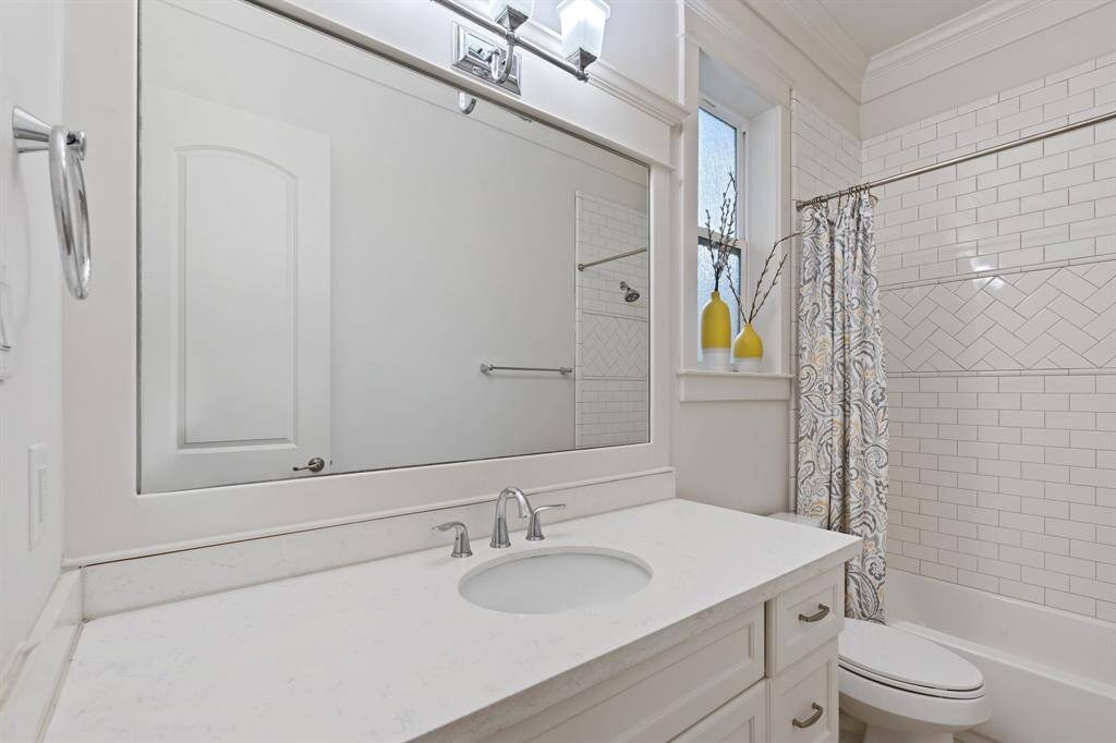The first floor bathroom features atub/shower combo with tile surround and long vanitywith plenty of counter space.