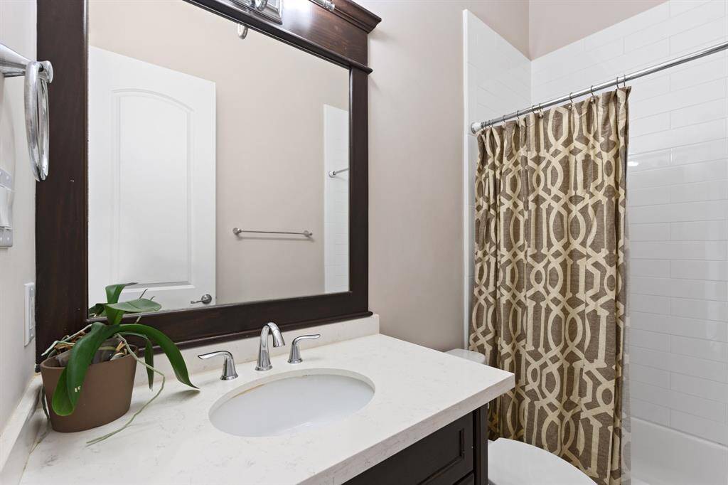 The second floor bathroom features atub/shower combo with tile surround.