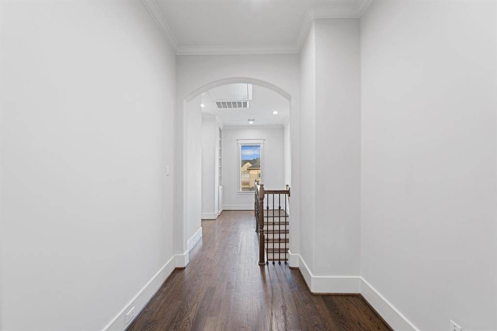 The third floor has beautiful flooring and archways.