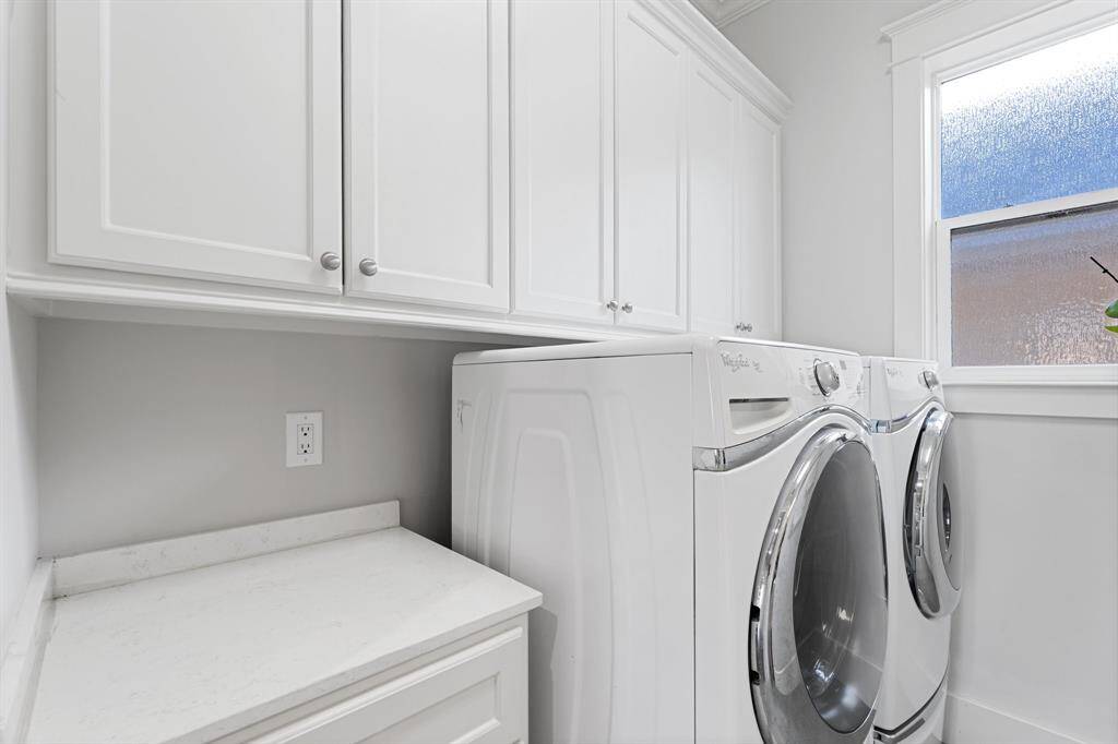 The laundry room features washer and dryer connections, cabinet storage space, and counter space.