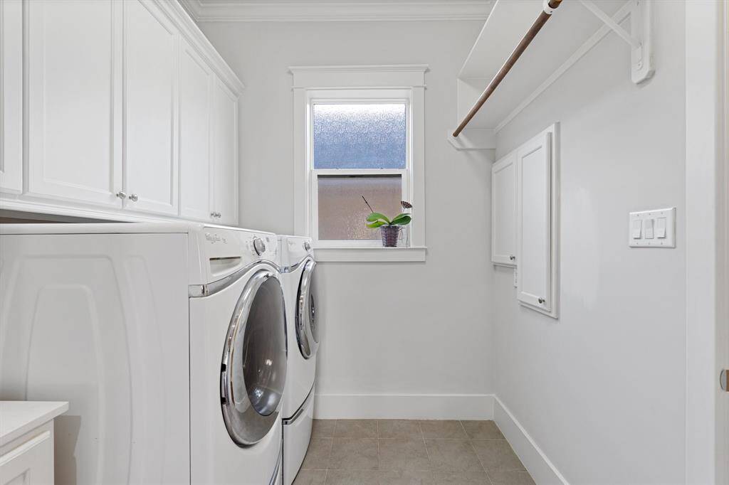 The laundry room features washer and dryer connections, cabinet storage space, and counter space.