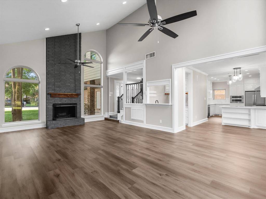 Floor to Ceiling Cozy Fireplace Sounded by Soaring Windows