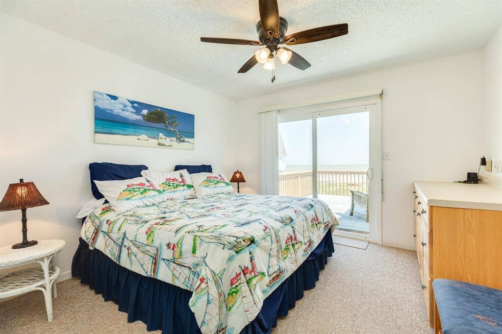 Primary bedroom has an ensuite bathroom and entrance to the back deck.   What a great view!  Built in cabinets will store away everything you need and just in case you need it - there is a walk in closet.  Tons of storage in this home.