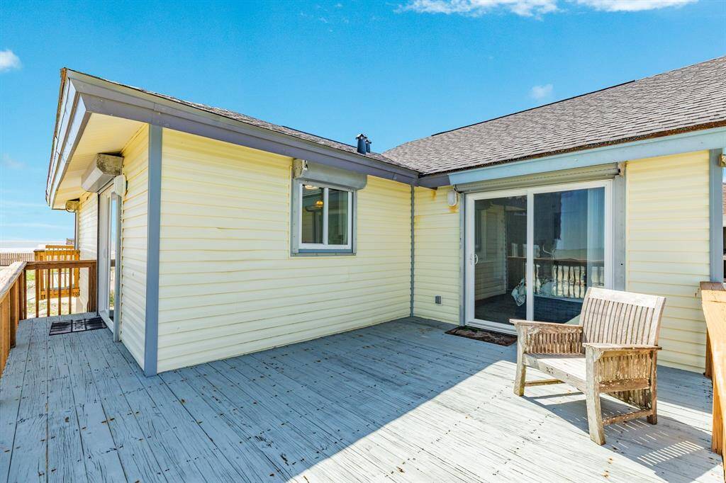 This is the back deck that connects to the primary bedroom and kitchen.  Another spot for catching a nap or reading a good book.