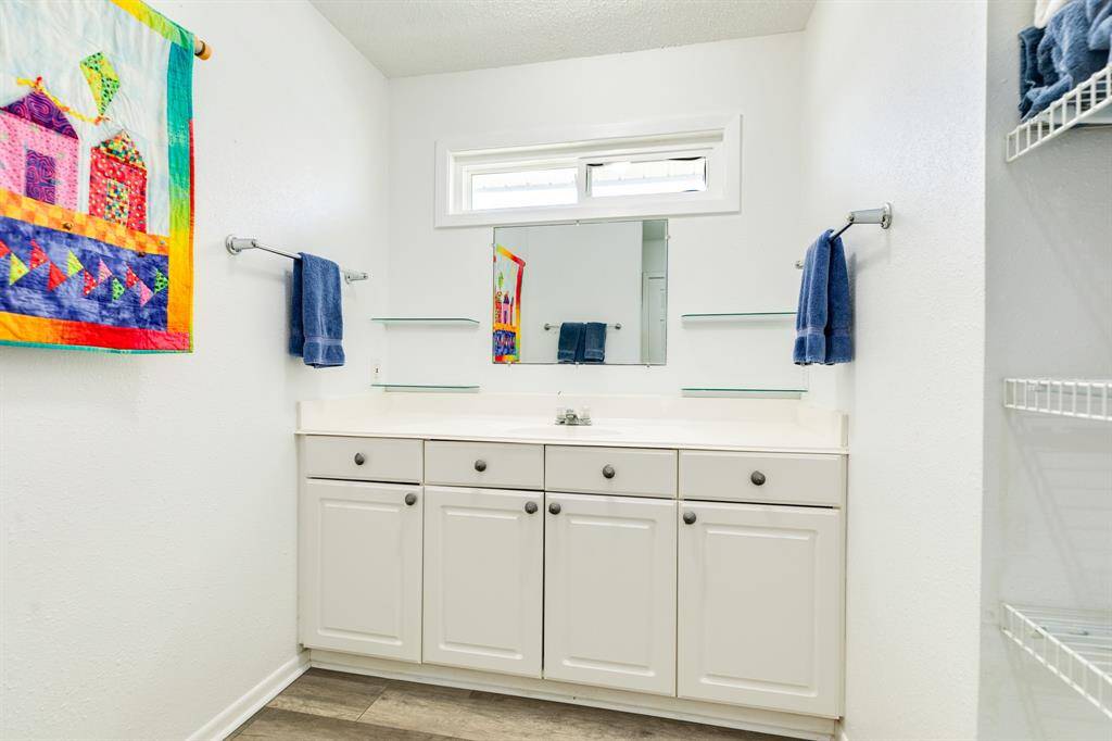 Primary bathroom has lots of storage and a walk in shower.