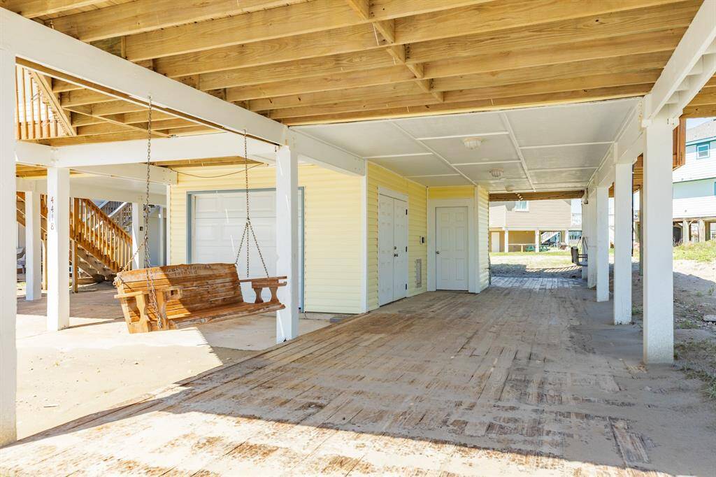This one story house is perfect for entertaining.  An open deck up top and covered space below.  Two porch swings are ready for you.