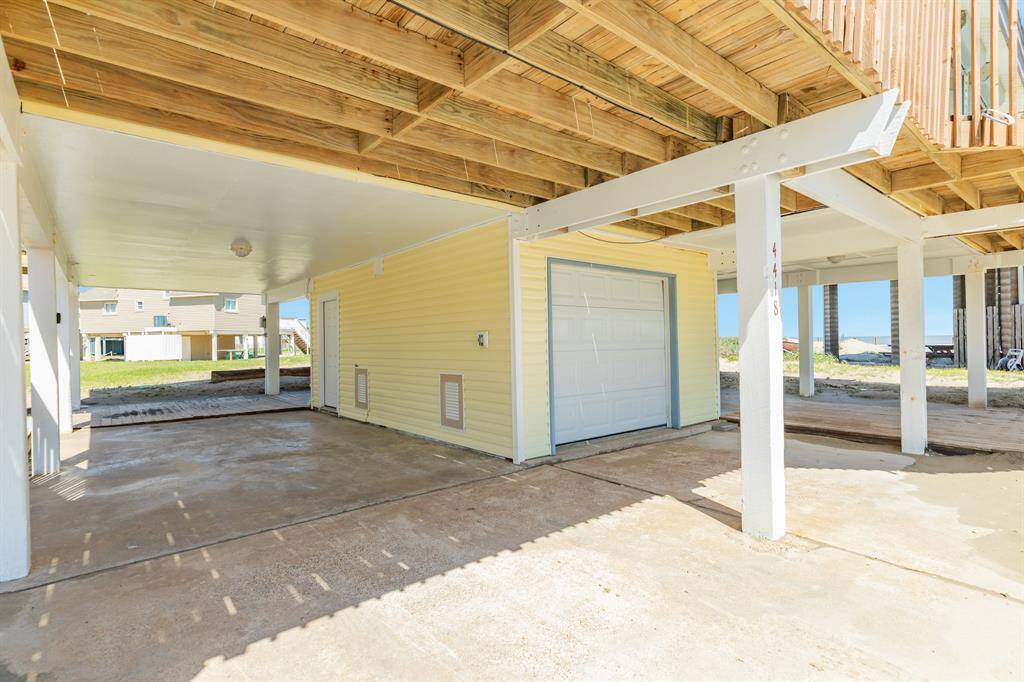 There is a half bathroom downstairs and an outside shower for your convenience. The pilings and ceiling are freshly painted.   The double doors open to the garage with plenty of room to store your golf cart and beach toys. The pilings and ceiling were freshly painted.