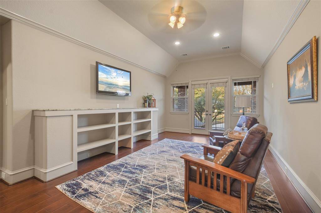 The gameroom has French doors that open to the private, covered balcony.