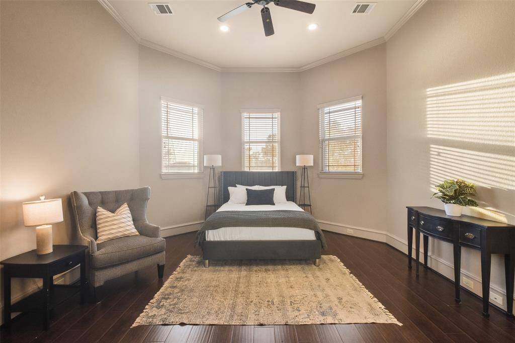 A spacious guest bedroom. The entire 2nd floor, with the exception of the media room, has hardwood flooring.