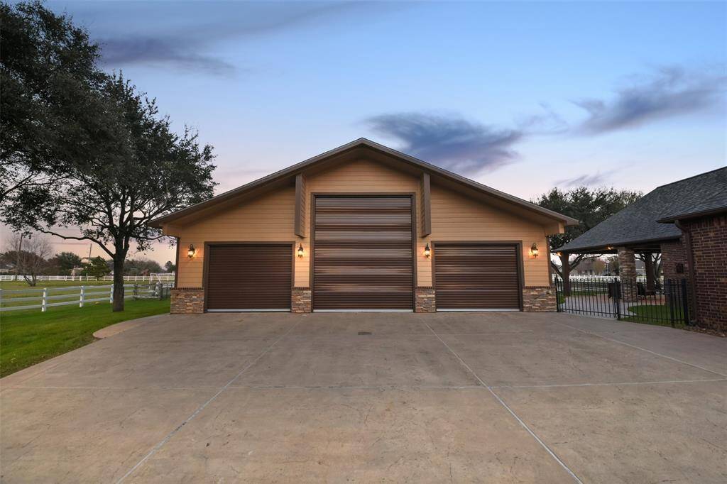 The standalone garage/workshop has one extra tall bay for RV/boat storage or a car lift, loft storage, spray foam insulated walls with all new rolling insulated remote doors, and an office with a half bath.