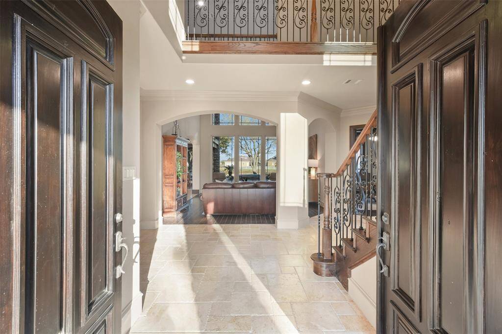 Double front doors open to the two story foyer.