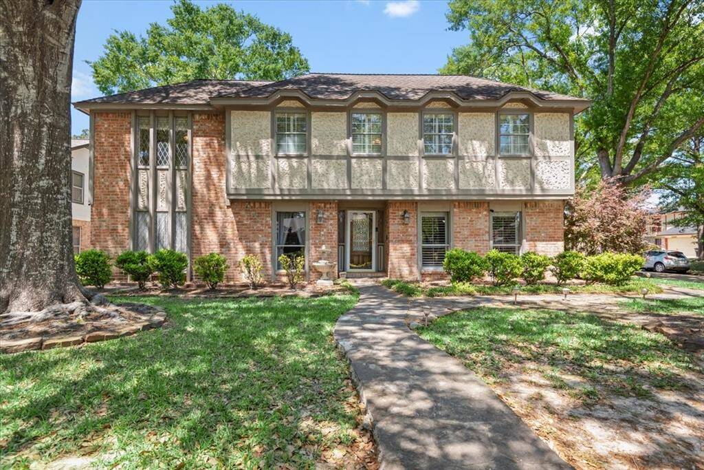This charming English Tudor custom built home sits on a corner lot with a 3-car garage.