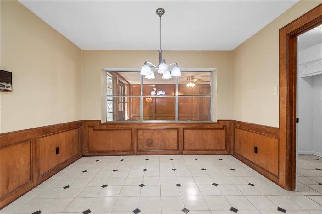 Large breakfast room with a view into the sun room.
