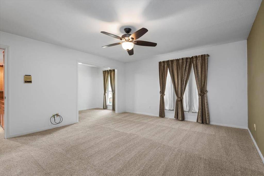 There is an office space that opens into the primary bedroom. This room could easily become a huge walk-in closet.