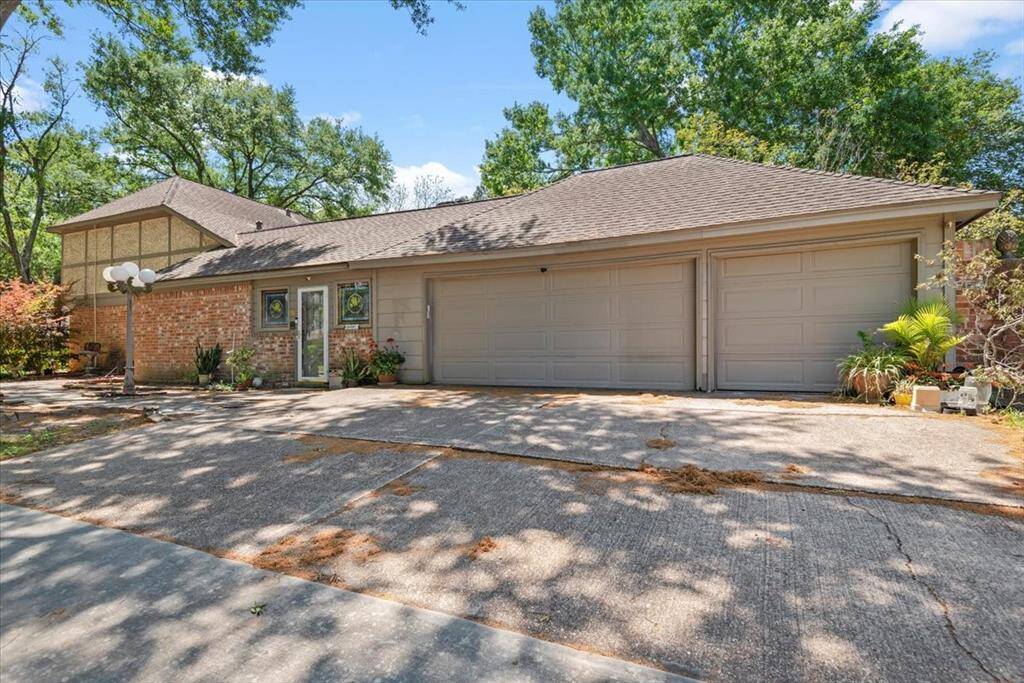 The 3-car garage opens on the side street. The door opens into a sunroom that connects between the laundry room and garage with access to the backyard.