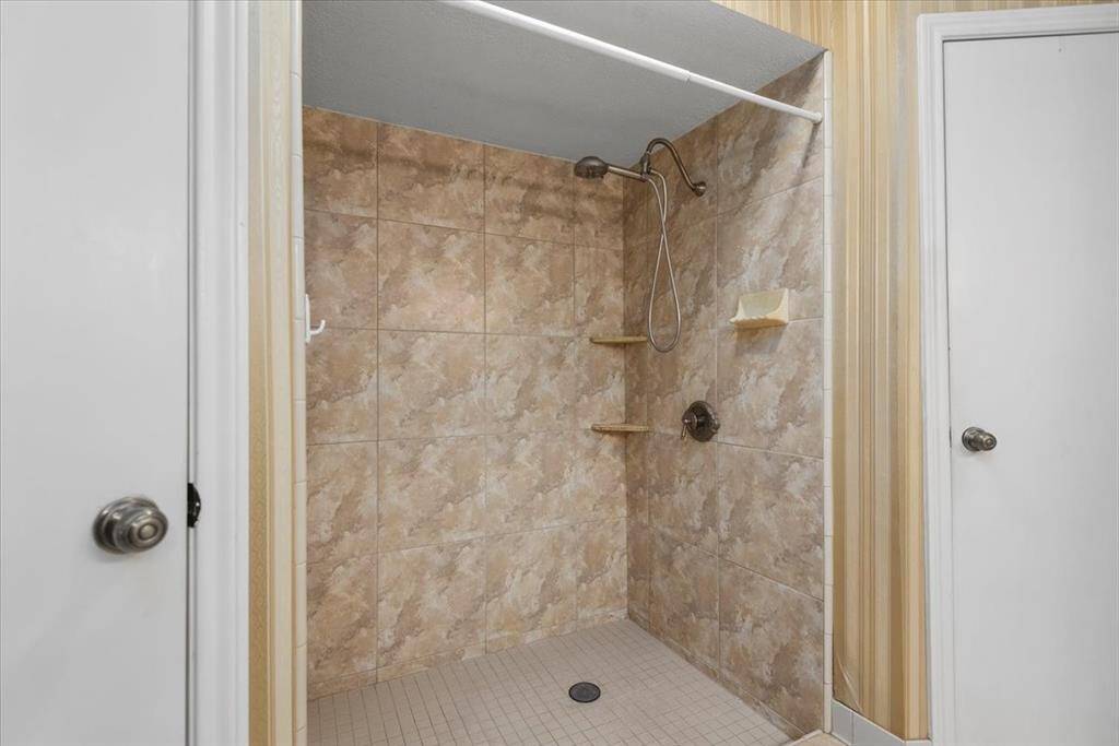 Notice the extra large walk-in shower. You don't have to share your closet because this bathroom has 2 closets!