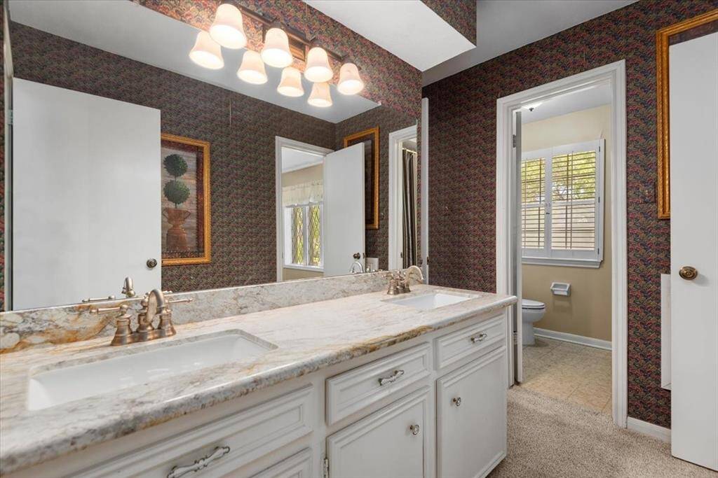 The upstairs bathroom features 2 sinks, granite counter tops and a combination tub/shower.