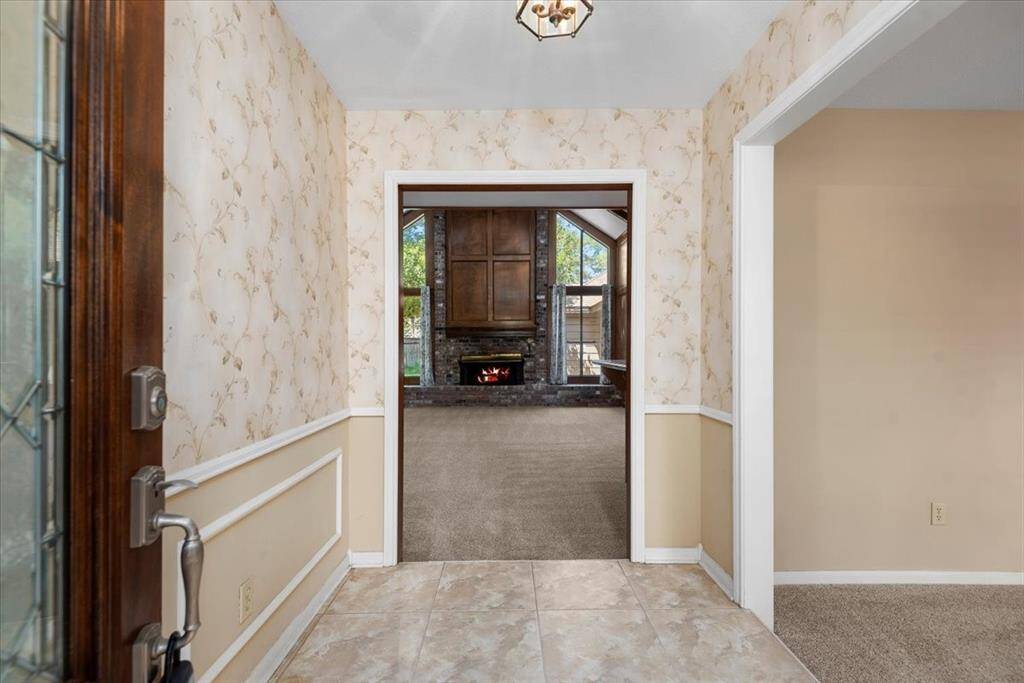 The formal dining room is to the right of the tiled entry.