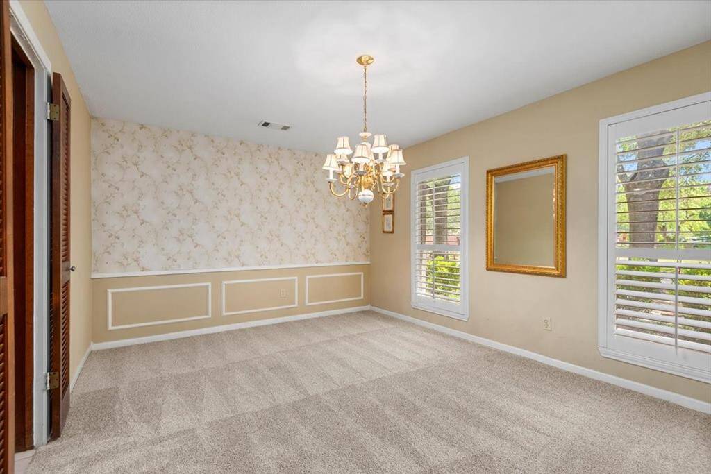 The formal dining room is large and has a door to conveniently access the kitchen.