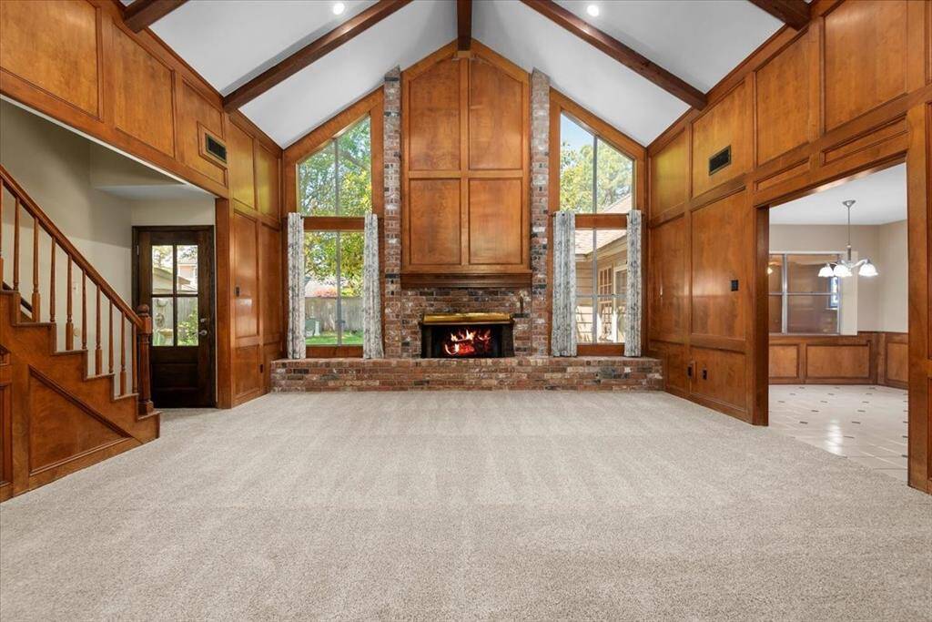 Wow! This living room is gorgeous. Stunning block paneling is in very good condition. The tall windows on either side of the fireplace allows tons of light into the room.