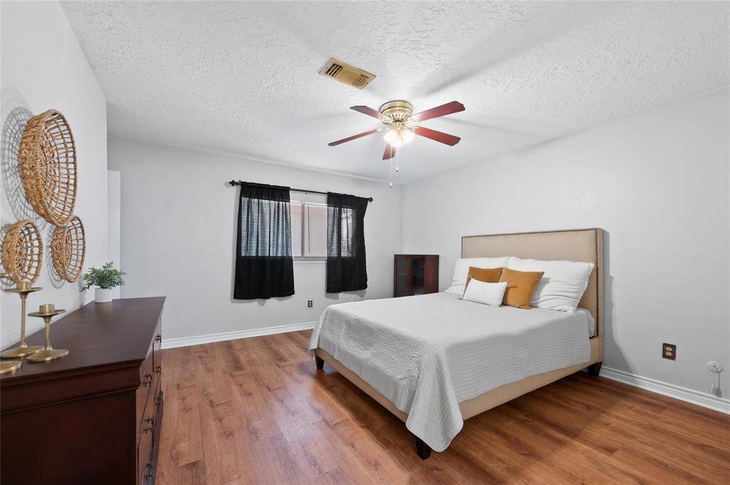 The primary bedroom features newly installed LVP flooring, an en-suite bathroom with a shower/tub combo and a large walk-in-closet.
