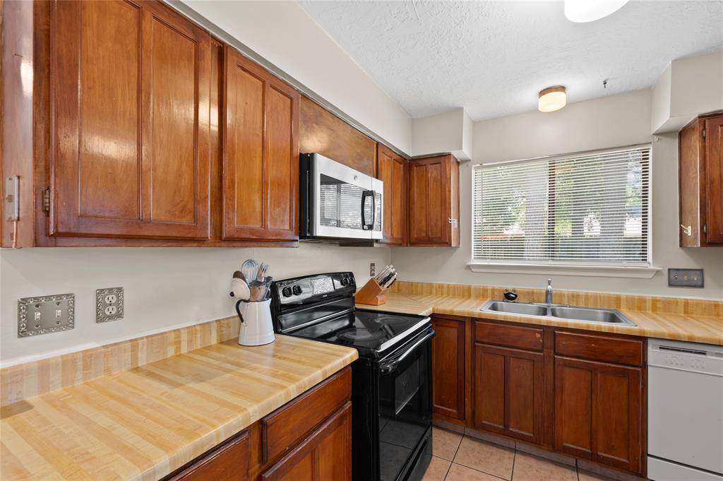 The kitchen offers plenty of cabinet and countertop space.