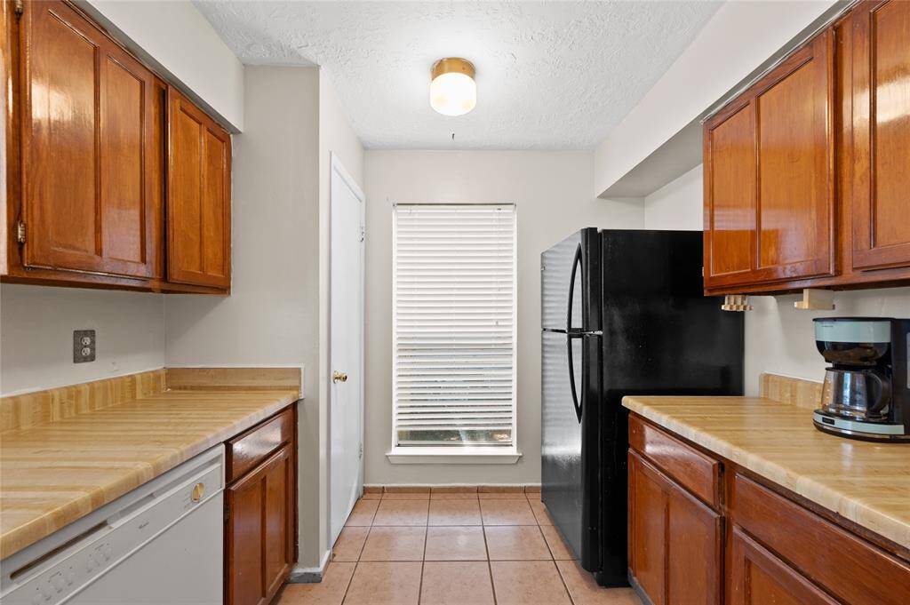 The kitchen offers plenty of cabinet and countertop space and a pantry.