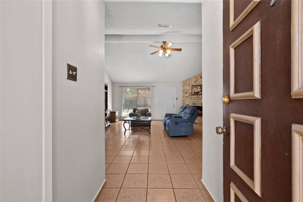 Upon entry, you'll notice easy-to-maintain tile floors, a large living room, and a beautiful brick fireplace.