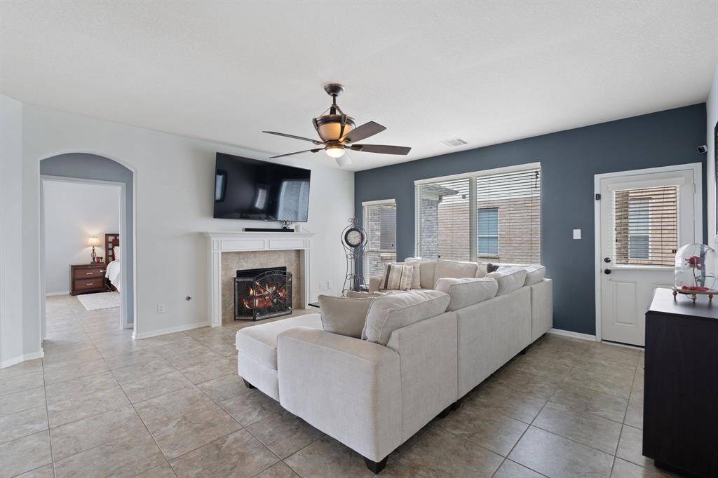 Spacious and filled with natural light, the living room easily accommodates a large sectional and centers around a cozy fireplace—perfect for relaxing or entertaining.
