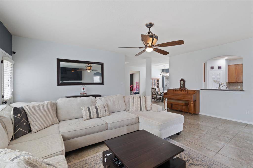A pass-through from the kitchen offers easy serving and conversation, while the nearby covered patio makes grilling and outdoor dining a breeze.