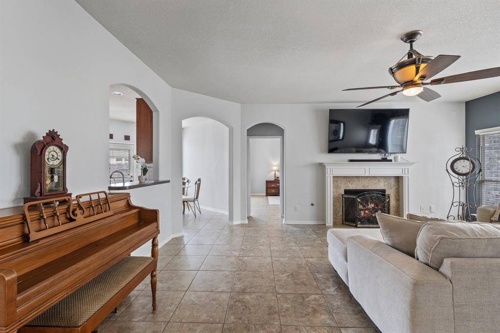 A view of the living space from the entry hallway, standing just beside the formal dining room and kitchen—looking toward the private entrance of the primary suite.