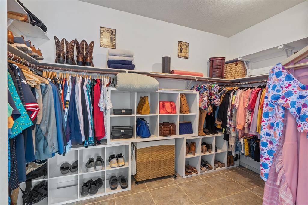 The primary closet offers generous space, featuring ample hanging areas, built-in shelving, and plenty of room for shoes, bags, and your favorite accessories.