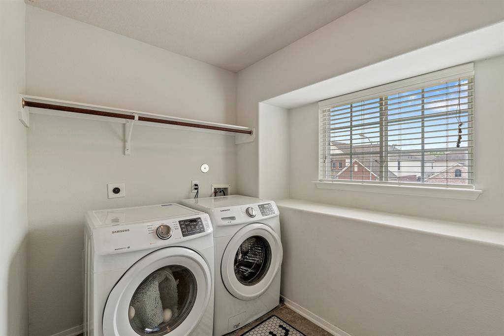 The oversized laundry room offers plenty of natural light, with space for storage, folding, and hanging—making everyday chores feel a bit more enjoyable.