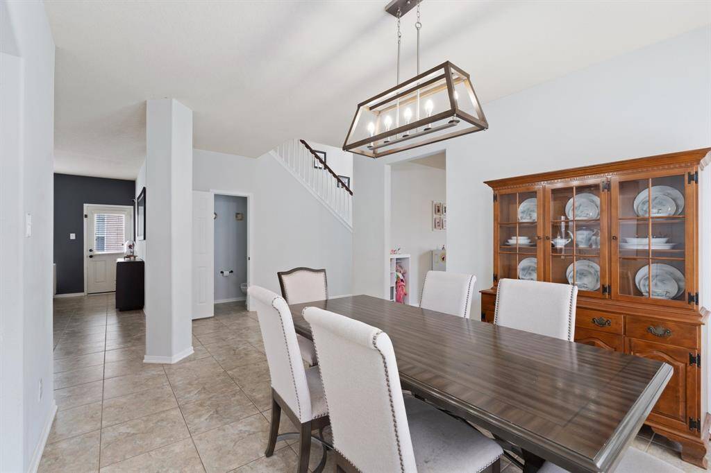 From the back of the dining room, you’ll enjoy a clear view into the spacious living room and easy access to the side patio—perfect for indoor-outdoor entertaining.