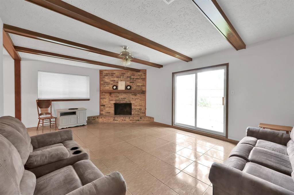 Large family room with wood burning fireplace that can also have gas logs.