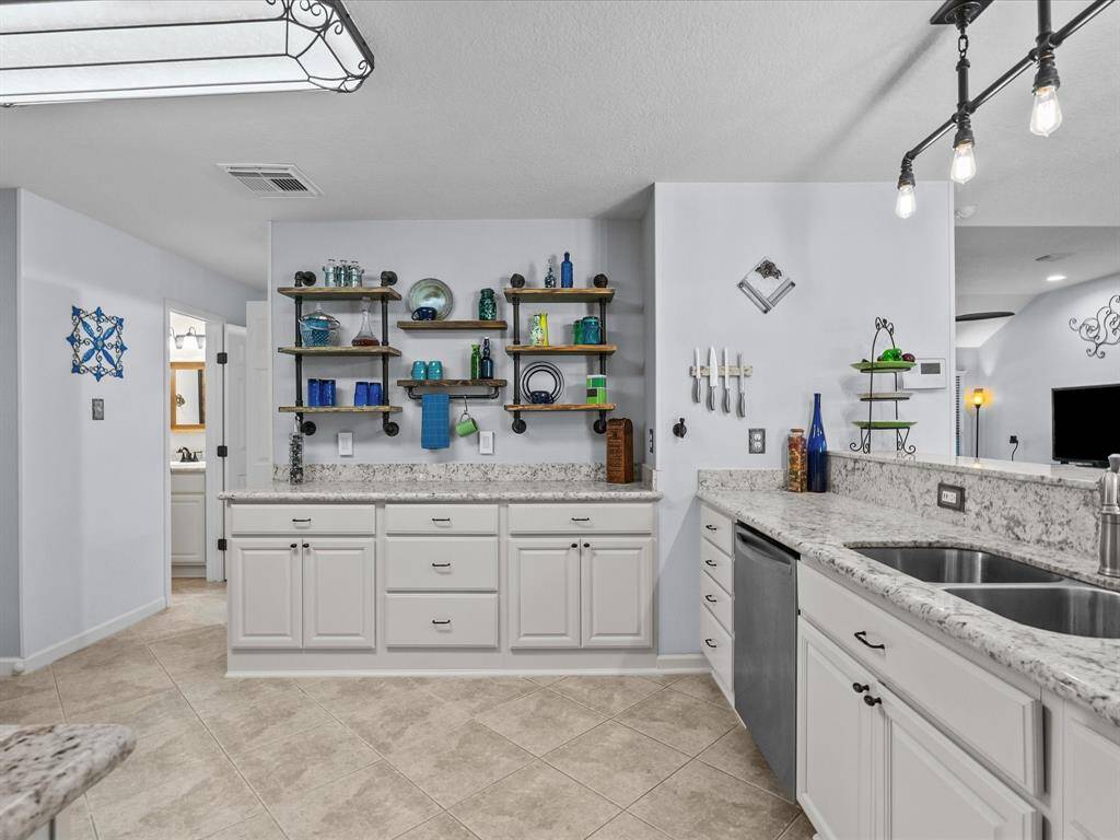 Lots of counter space and choose to add the open shelving on this one wall that gives just the right touch to this updated kitchen.
