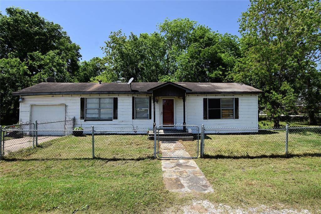Classic curb appeal with a covered front porch and mature trees. The structure is solid, just waiting for the right vision to bring it back to life.
