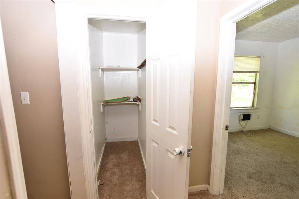 One of two roomy hall closets, offering ample space for linens, cleaning supplies, seasonal items, or everyday essentials.