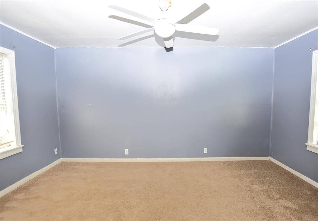 Spacious and filled with natural light, this room offers plenty of space for a full bedroom setup and personal touches.