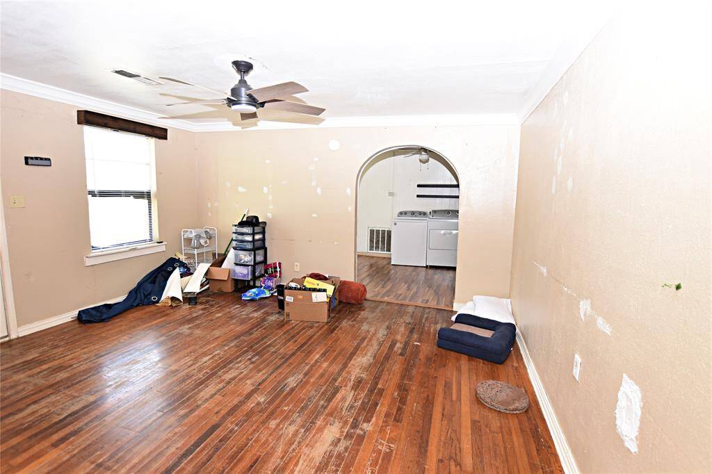 Spacious layout with natural light pouring in. Original hardwood floors  offer restoration potential.