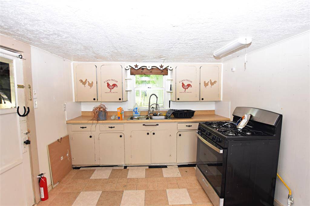 Functional space with room to expand or redesign. Perfect blank canvas for a modern upgrade. Stove Excluded in Sale.