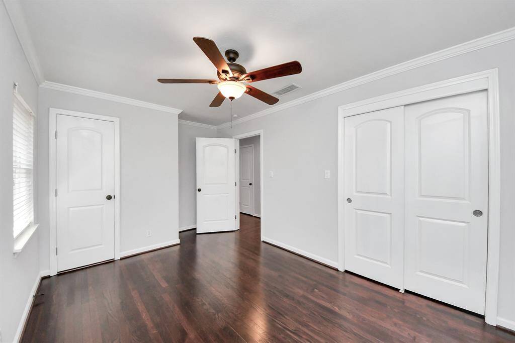 Primary BR shows door to bathroom & sliding closet doors