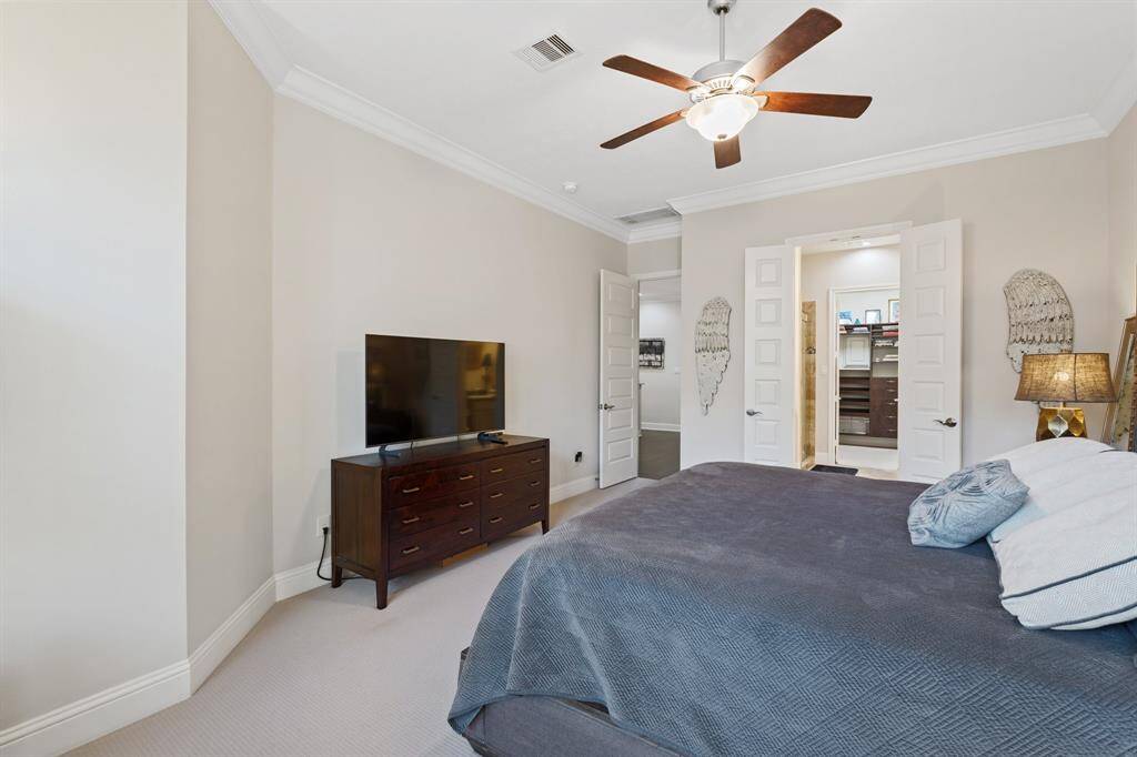 The Primary bedroom sits just off the family room toward the back of the home. Upscale finishes with crown molding and larger baseboards.