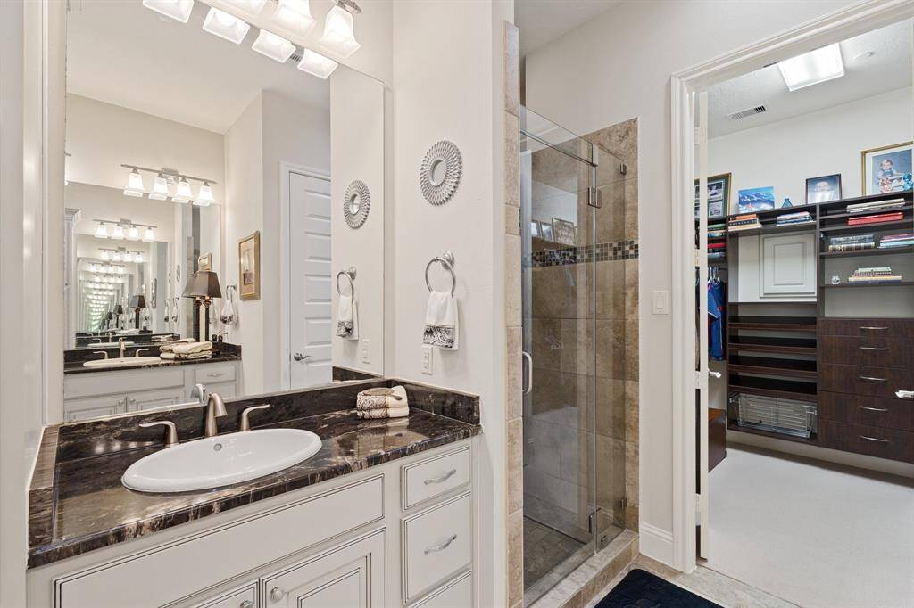Opposite view of the primary bathroom and view of the shower.