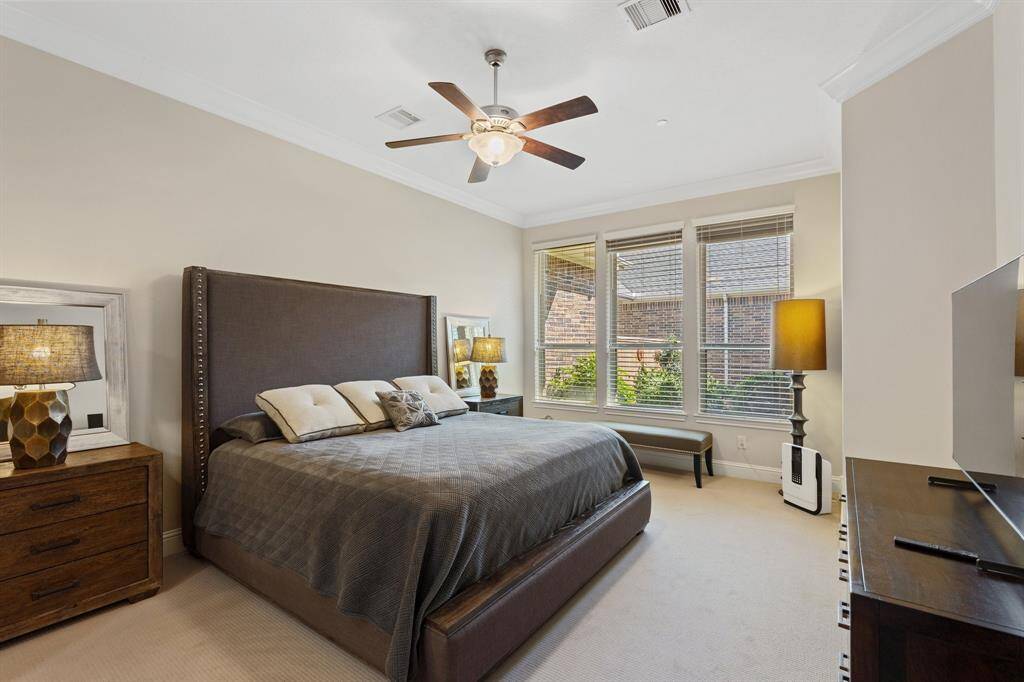 Spacious primary bedroom with three large windows allowing ample light in this space.