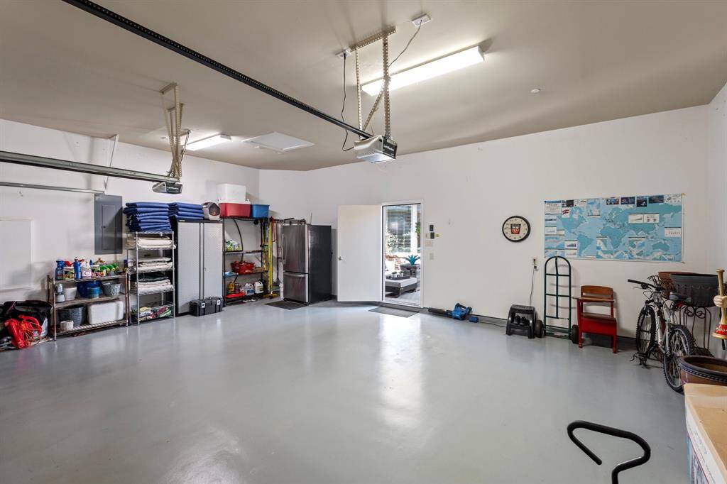 Three car garage complete with sheetrock and epoxy flooring for easy clean and less tracking of dirt.