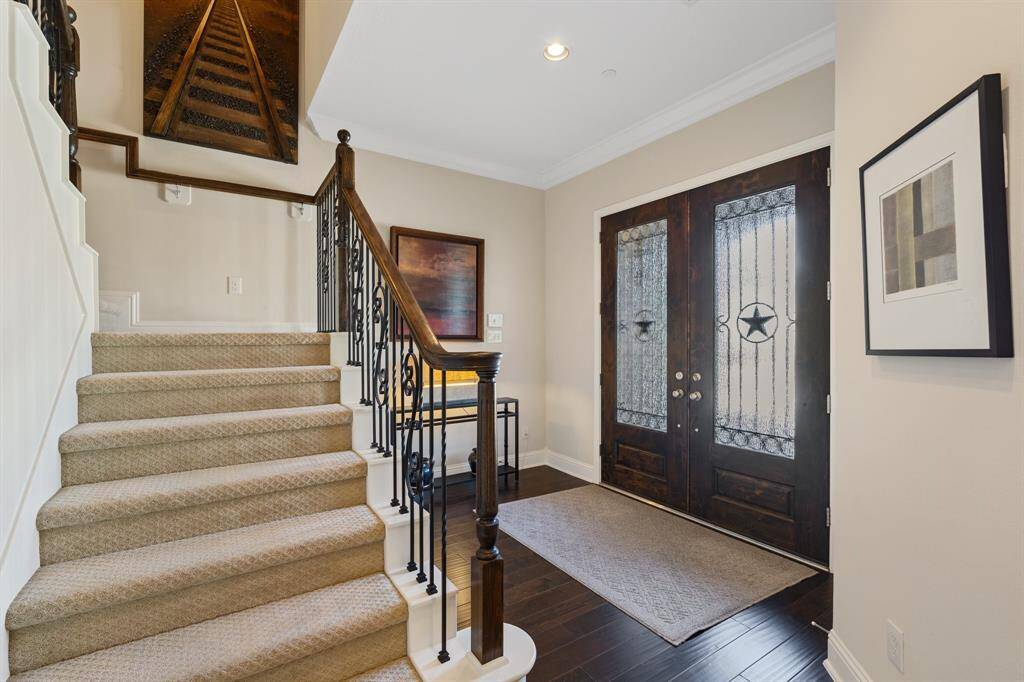 Following the flow of the home from the entryway through the handsome wood double doors.