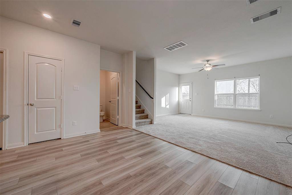 Stairs are tucked away in the living area and the back door offers direct access to the backyard.