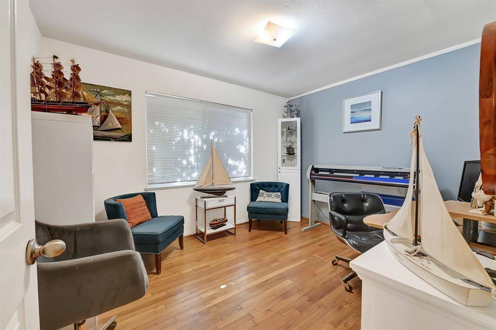 This room features hardwood floors and offers a versatile space for a home office or reading nook.