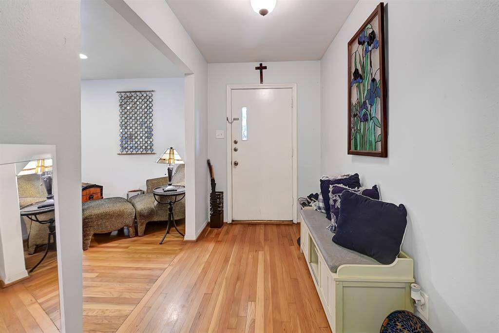 This welcoming entryway features hardwood floors and it leads into a bright living room.